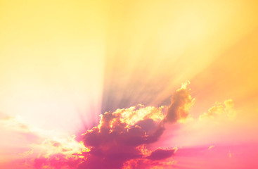 Fototapeta premium bright sun Behind neon light pink clouds with orange light and sun rays