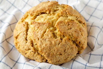 Homemade Irish Soda Bread on cloth, side view. Close-up.