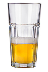 An isolated casablanca type glass half full of foamy light beer 