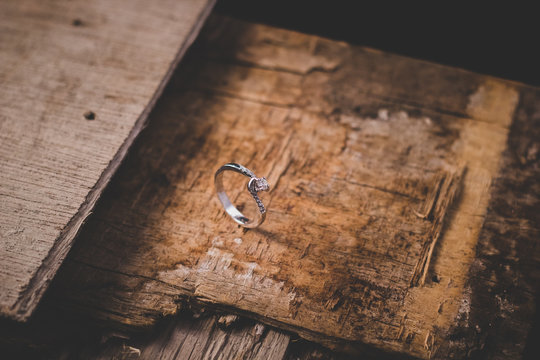 Beautiful diamond ring on old and rustic wood.Still image-single product photography.Good for marriage proposal theme,romantic greeting card or any printed media.