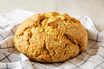 Homemade Irish Soda Bread on cloth, side view. Close-up.