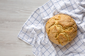 Homemade Irish Soda Bread on a white wooden surface, top view. Flat lay, overhead, from above....