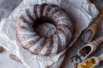 Round chocolate coffee cupcake with raisins and poppy