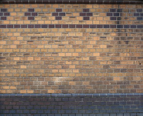 Wall of light brown and dark brown bricks
