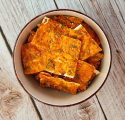 Homemade chips with cheese and herbs