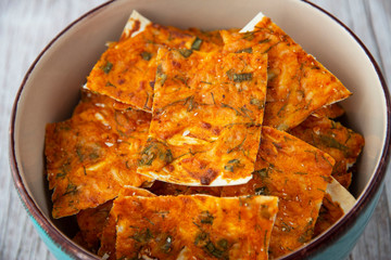 Homemade chips with cheese and herbs