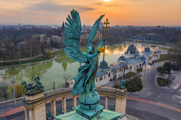 Budapest, Hungary - Aerial view of Gabriel Archangel at Heroes' Square during the 2020 Coronavirus quarantine in the morning. Vajdahunyad Castle and City Park at background with a warm sunrise