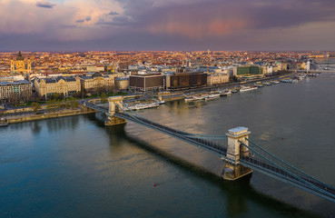Budapest, Hungary - Aerial view of the Szechenyi Chain Bridge at sunset with colorful sky and St.Stephen's Basilica. The bridge and the streets are totally empty due to 2020 Coronavirus quarantine