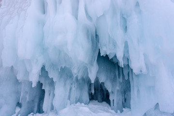 Fototapeta na wymiar Icicles background on the ice wall on Baikal lake at winter