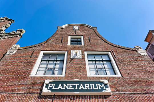 Facade of the Eise Eisinga Planetarium in Franeker The Netherlands with sundial and blue sky.