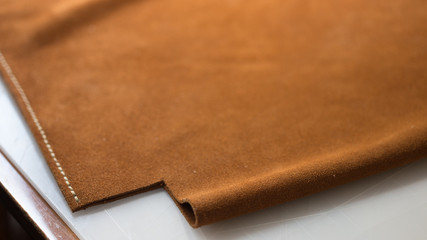 Handmade handicraft leather bag sewing process. Leather workshop, working leather