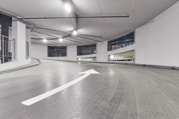 Circular climb to the parking. Underground garage parking. Automobile parking inside.