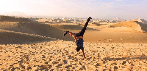 man doing stunts in the desert
