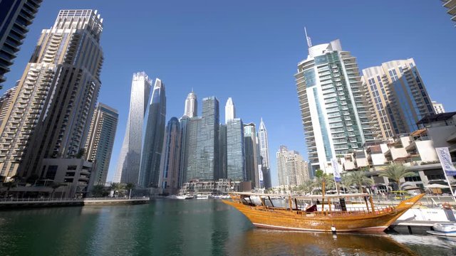 Wooden boat docked at marina in downtown Dubai city center, United Arab Emirates
