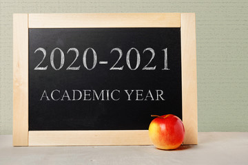 School board with text academic year 2020 2021. Background School blackboard and apple.