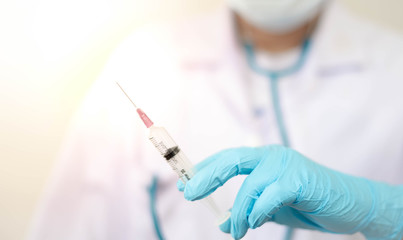 Syringe medical injection in hand holding with medicine dose vaccination equipment with needle.