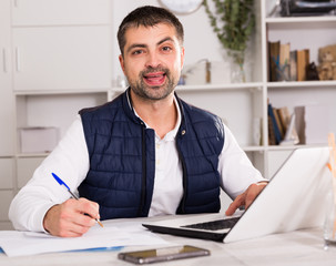 Portrait of male business working in office with laptop