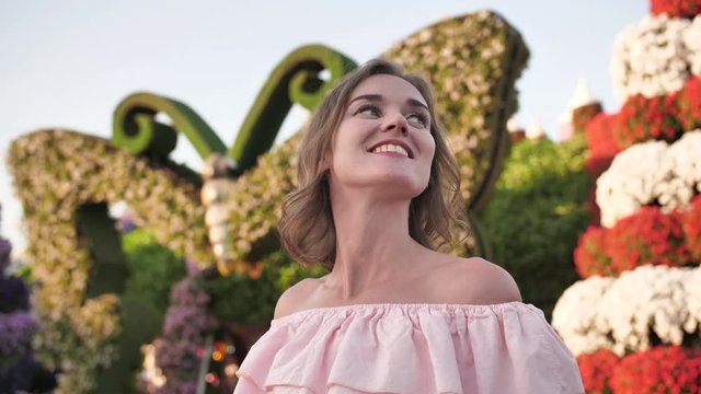 A girl walks through a beautiful fairytale park in Dubai.