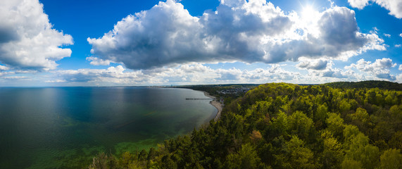 Beautiful panorama of the sea and the forest on a cloudy day. Aerial view of sea landscape with mountain and forest.