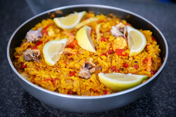 Seafood paella, traditional spanish food. Pan full of rice cooked with vegetables, shellfishs and shrimps