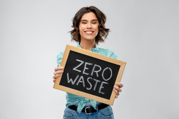 eco living, environment and sustainability concept - portrait of happy smiling young woman in...