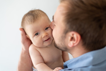 Young father holding his newborn baby daughter
