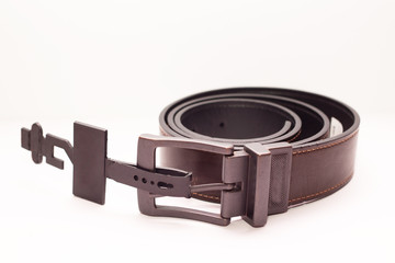 Close-up new classic men's brown leather belt on a white background. 