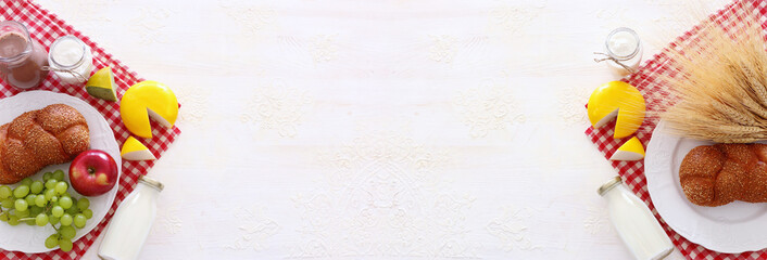 Top view photo of dairy products over white background. Symbols of jewish holiday - Shavuot