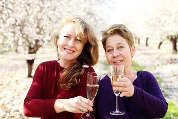 Outdoor portrait of two best friends women celebrating the end of isolation