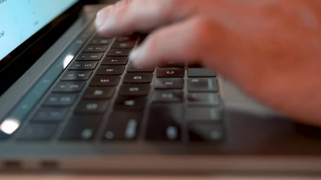 Man typing on a laptop keyboard. 
Shot in 4k with a Sony FS7 ii