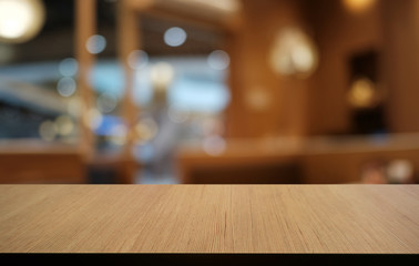 Empty dark wooden table in front of abstract blurred bokeh background of restaurant . can be used for display or montage your products.Mock up for space.