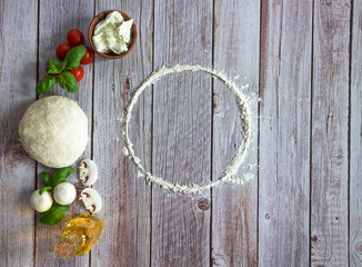 Baking template with italian pizza dough and fresh ingredients. Top view, copy space