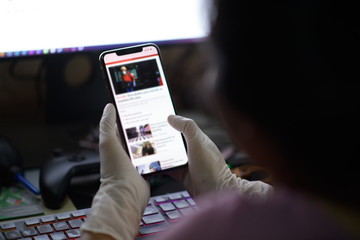 Online news on a mobile phone. Close up of businesswoman reading news or articles in a smartphone...