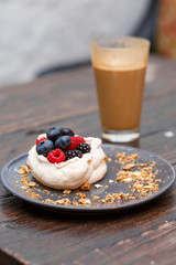 Sweet cakes with summer berries on a wooden table. Party, sweet table. Summer offer desserts in the restaurant.