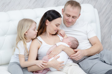 Fototapeta na wymiar Sleeping baby with mom and dad. Newborn Concept.
