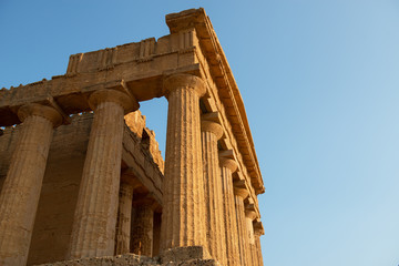 Fototapeta premium Valley of the Temples (Valle dei Templi), an ancient Greek Temple built in the 5th century BC, Agrigento, Sicily. Famous tourist attraction in Italy. Old marble columns of the Doric order.