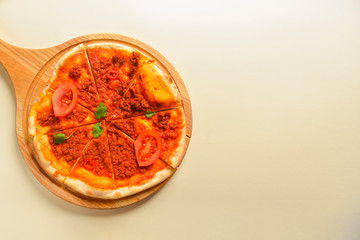 Traditional italian food. Delicious fresh pizza with bolognese sauce, tomatoes, pepper on wooden board, flat lay.