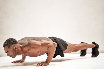 Embossed fitness couch doing a plank excersise looking powerful