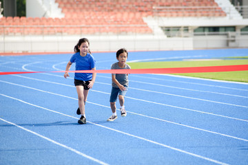 Fototapeta premium Young boy run to finished line.