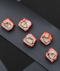 Japanese sushi rolls on dark background. 