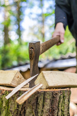 Holz hacken von Handmit der Axt für Brennholz im Winter