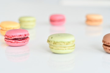 Cake macaron or macaroon on white background, sweet and colorful almond cookies with various pastel colors, vintage look. Different types of macaroons are a delicious dessert.