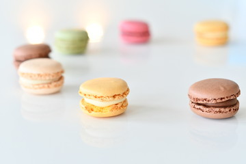 Fototapeta na wymiar Cake macaron or macaroon on white background, sweet and colorful almond cookies with various pastel colors, vintage look. Different types of macaroons are a delicious dessert.