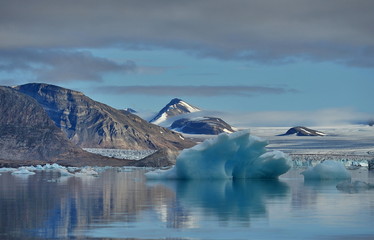 Blue ice drifting iceberg. Landscape of the Svalbard archipelago.