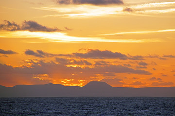 Bright sunset on the Atlantic Ocean. View from the open ocean to the Canary Islands.