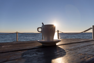 coffee at sunset on a terrace by the sea