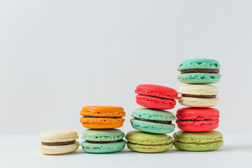 Beautiful colourful desserts. French macaroons on a white background