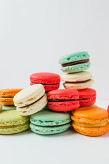 Beautiful colorful desserts. French macaroons on a white background	