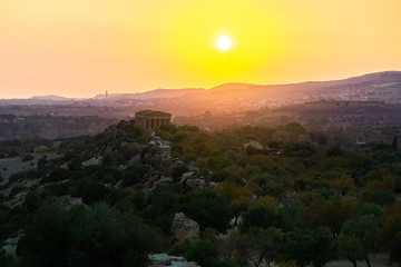 Sunset at Valley of the Temples (Valle dei Templi), ancient Greek Temple built in the 5th century BC, Agrigento, Sicily. Famous tourist attraction in Italy. Sicilian landscape, travel destination