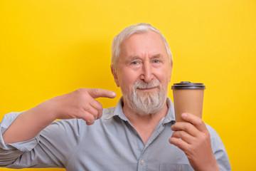 Senior man is holding coffe mug copy space. Seniors morning.